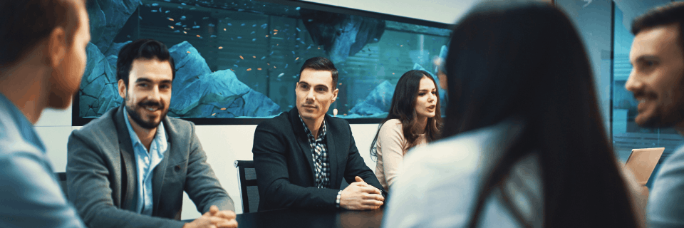 CRM and delivery team working together on a laptop, reflecting hands-on guidance across programmes at different stages.